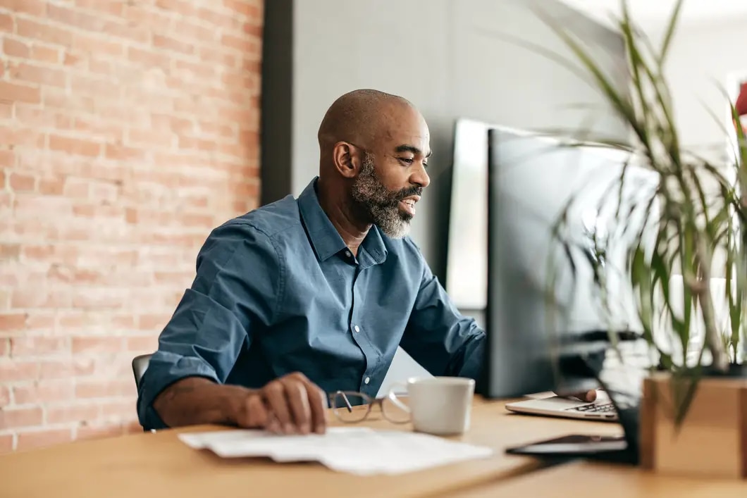 professional sitting at desk working on computer